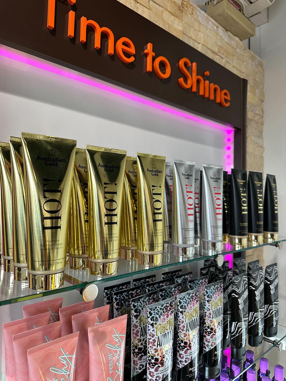 Australian Gold HOT tanning lotions on display shelf in The Tanning Shop UK store