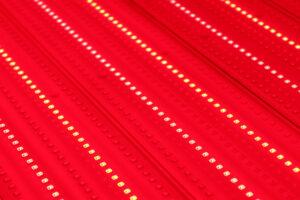 Red light therapy benefits - close-up of red LED light therapy panel at The Tanning Shop UK