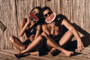 Tanned couple enjoying sunless spray tanning results at The Tanning Shop UK automated spray tanning machines