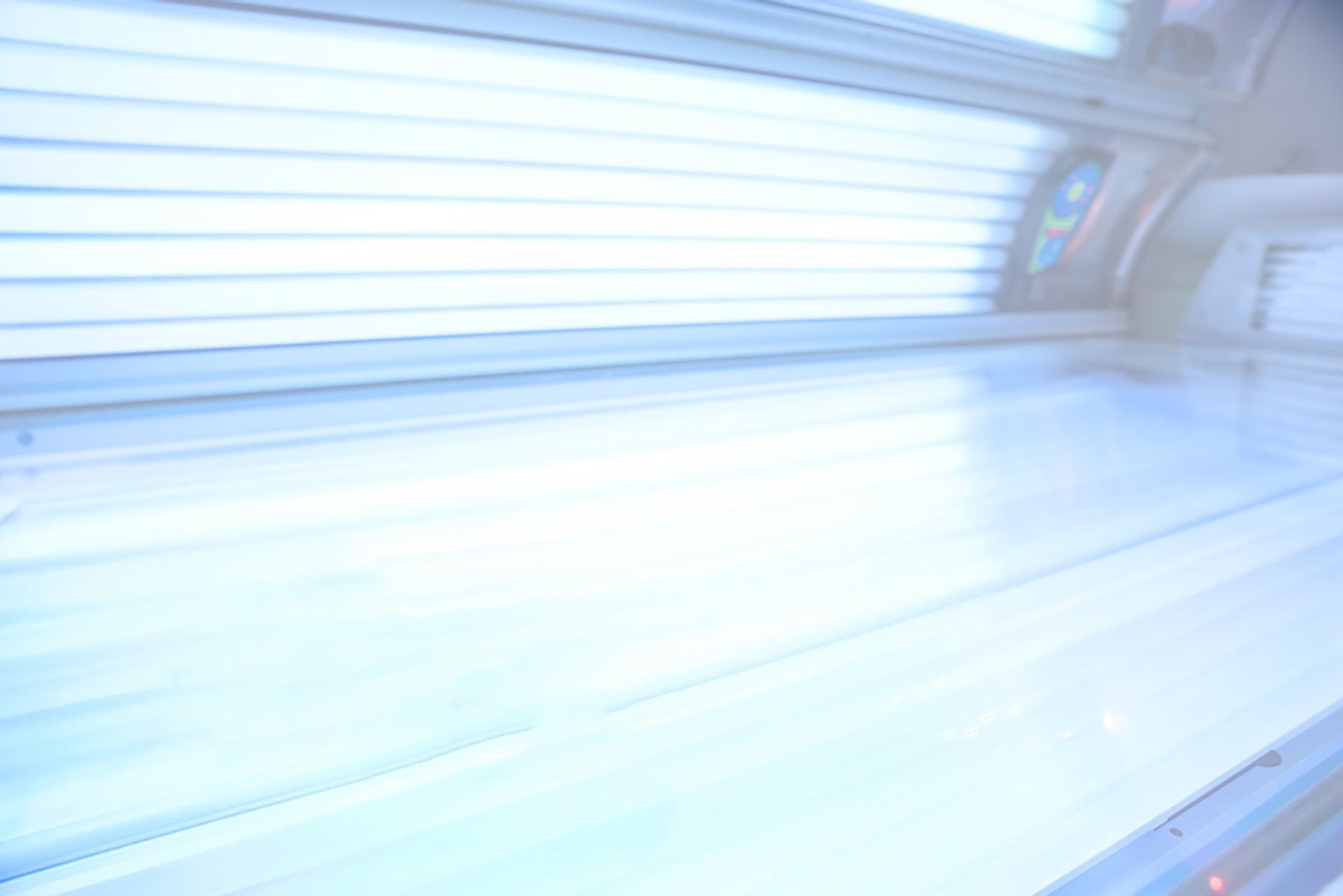Close-up of UV tanning bed lamps illuminated inside a sunbed at The Tanning Shop UK