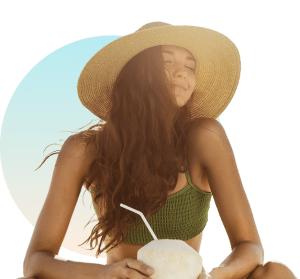 Tanned woman in sun hat drinking coconut on sunny summer day at The Tanning Shop