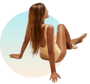 Woman with sun-kissed tan in yellow swimsuit enjoying sunshine at The Tanning Shop