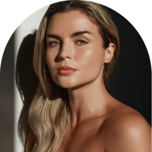 Woman with long blonde hair and bare shoulders showing bronzed spray tan skin, representing how to prepare for a spray tan