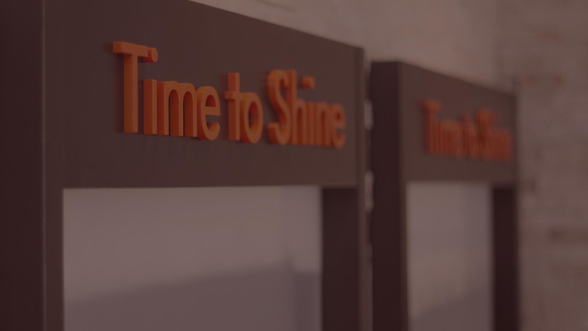Close-up of Time to Shine branded tanning room doors inside a Tanning Shop UK salon
