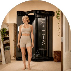 Smiling Customer Stepping Out Of A Wellfit Spray Skincare Booth After A Full Body Skin Treatment At The Tanning Shop